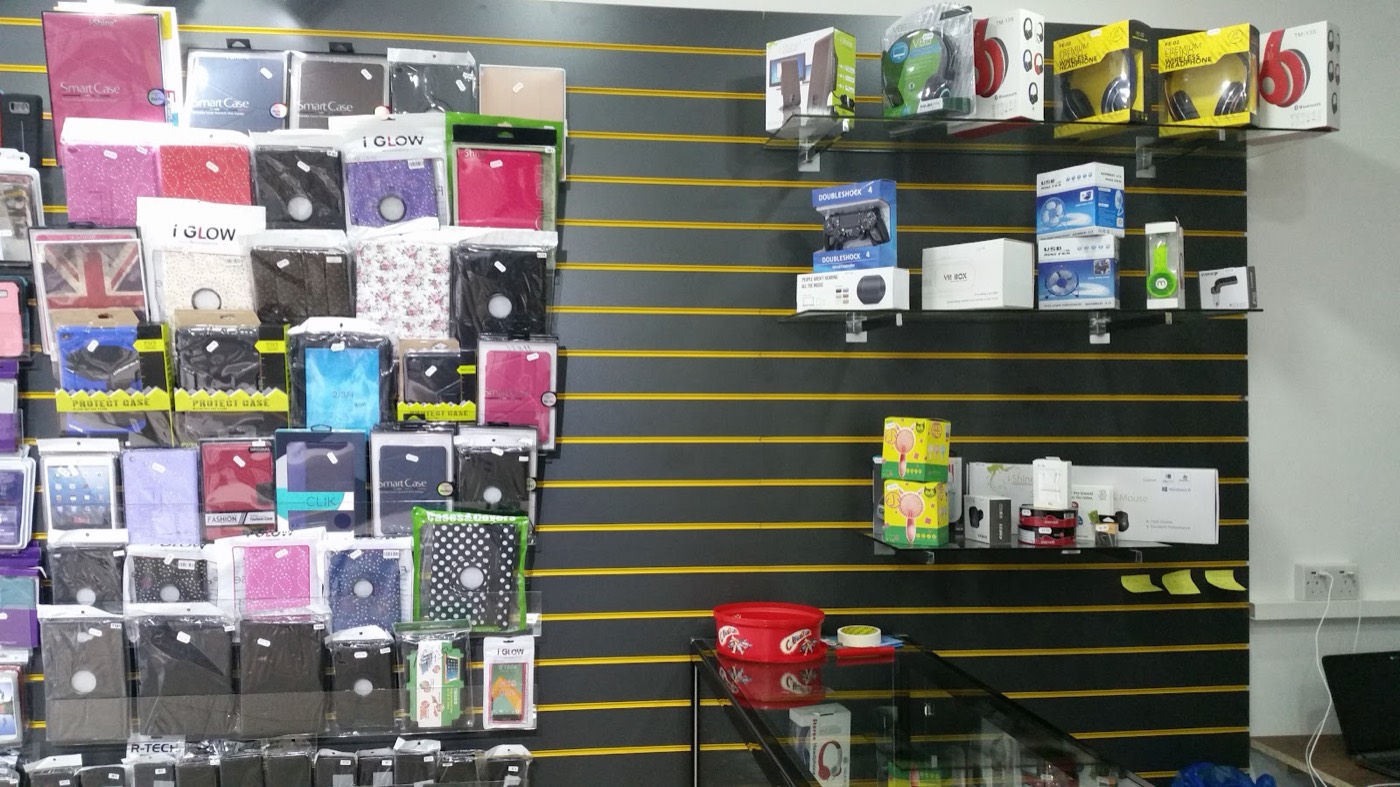 Racks of phone and tablet cases, tempered glass and wireless headphones on the accessory wall at World Phone Fix.